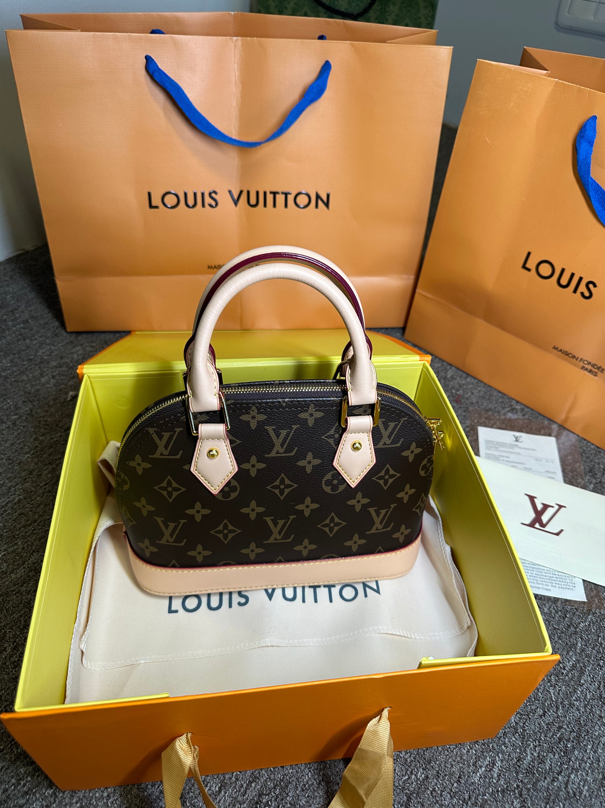 Bolsa de mão Louis Vuitton Alma BB monograma PVC couro marrom