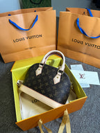 Bolsa de mão Louis Vuitton Alma BB monograma PVC couro marrom
